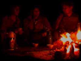 RM conversing around a Nomad Camp fire